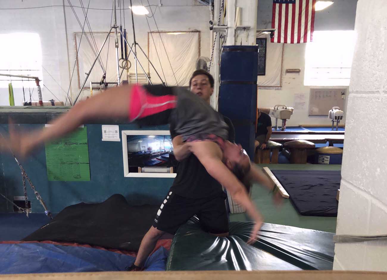Cheer students practising back handsprings